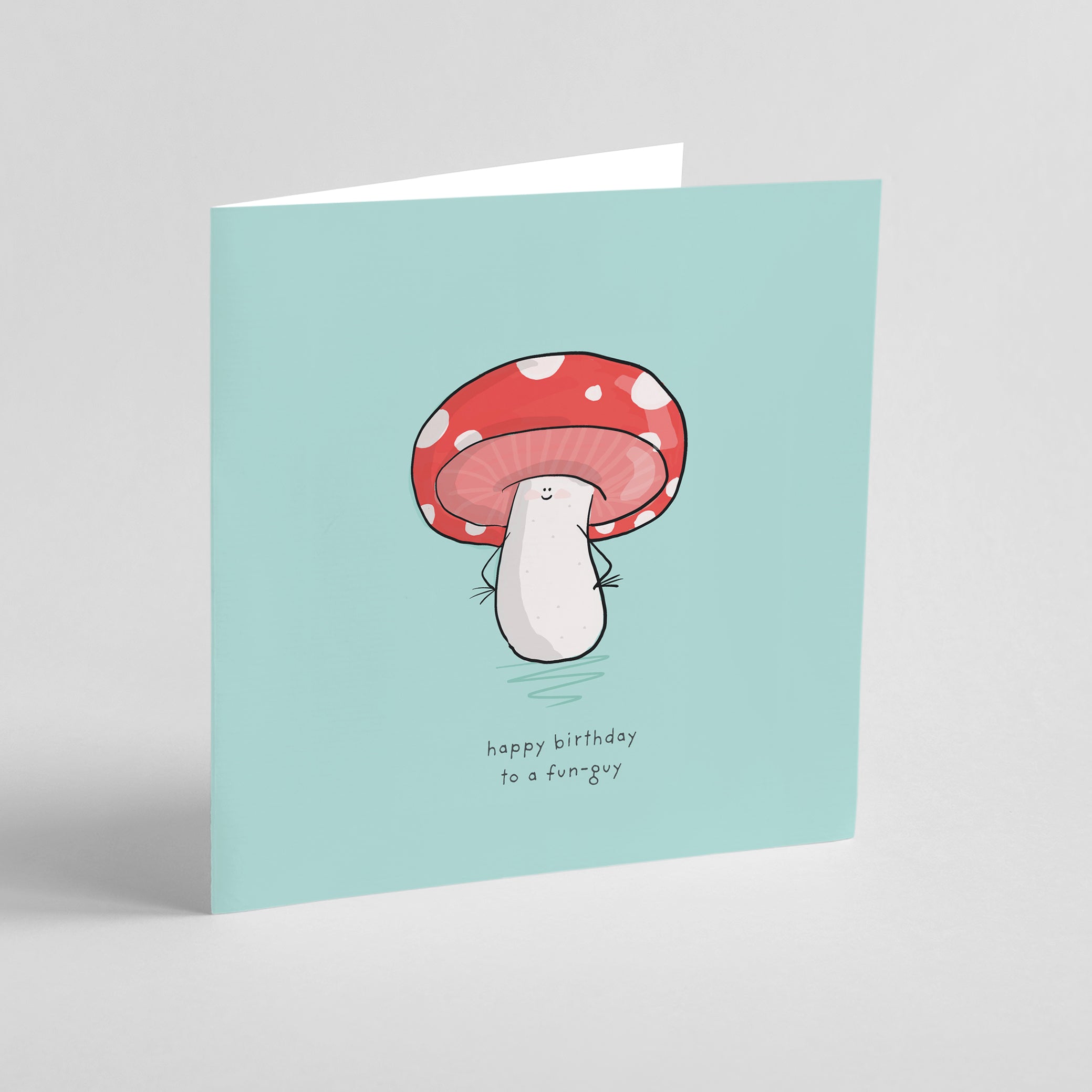 A birthday card with a cartoon mushroom on a light blue background.