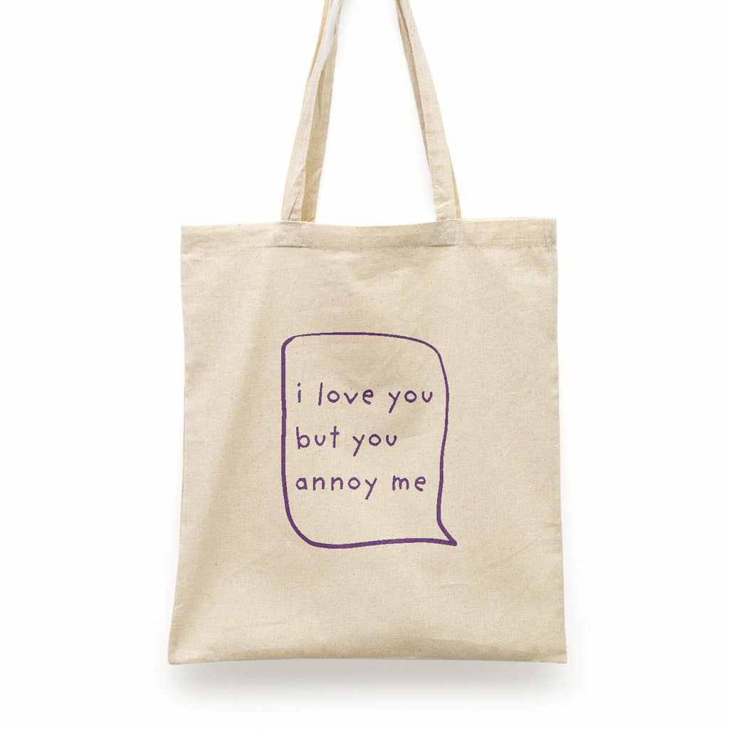 Whimsical 'I Love You But You Annoy Me' cotton tote bag featuring a humorous message, ideal for those who appreciate a blend of love, humor, and practicality in their accessories."