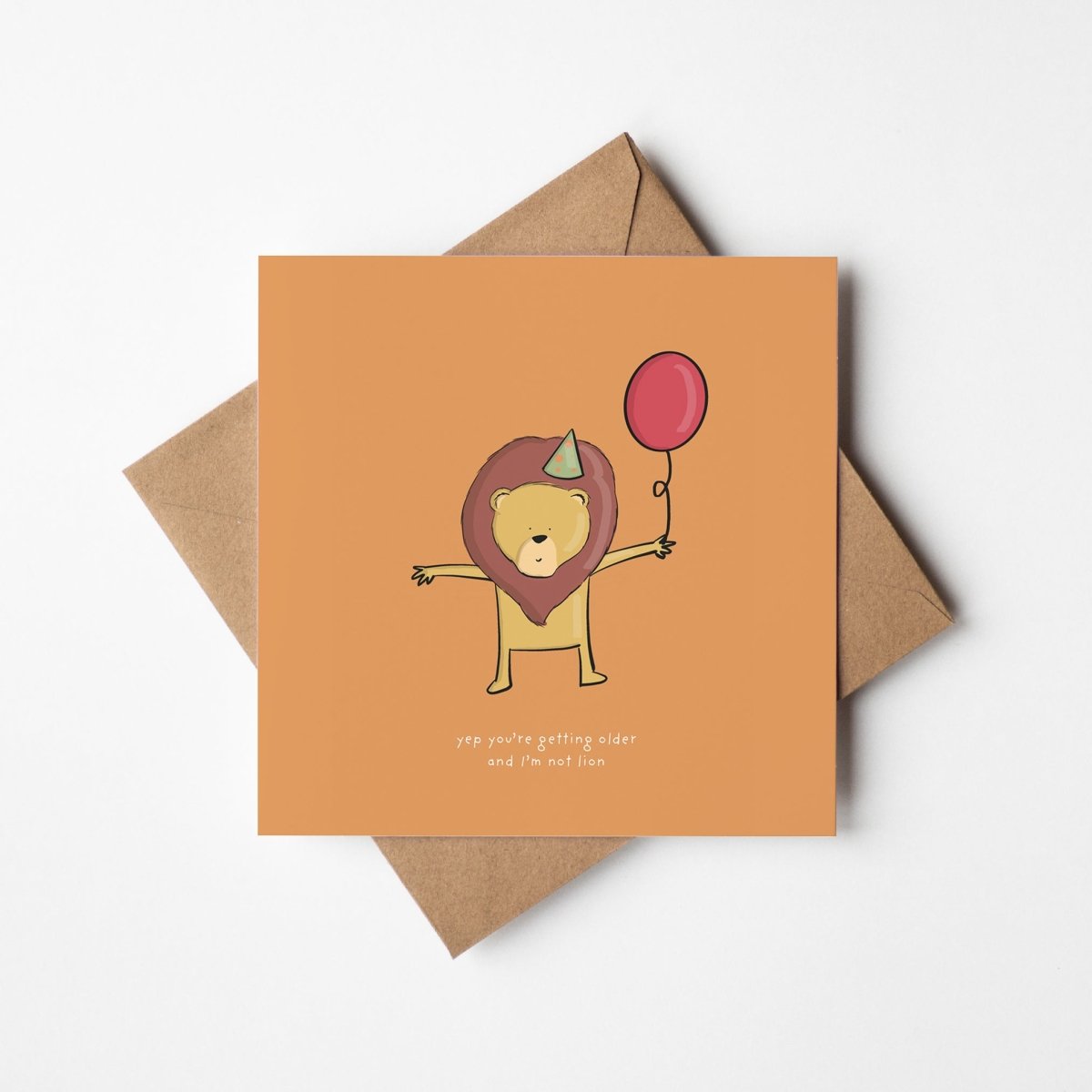 Cute lion wearing party hat holding balloon birthday card
