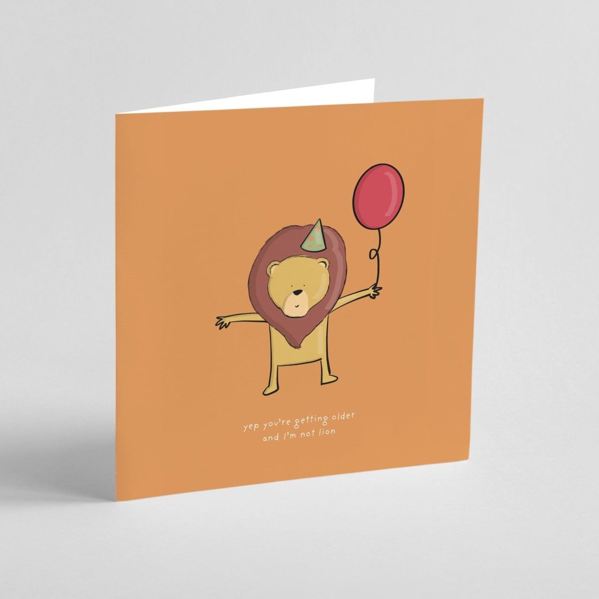 Birthday card featuring adorable lion with party accessories and pun text