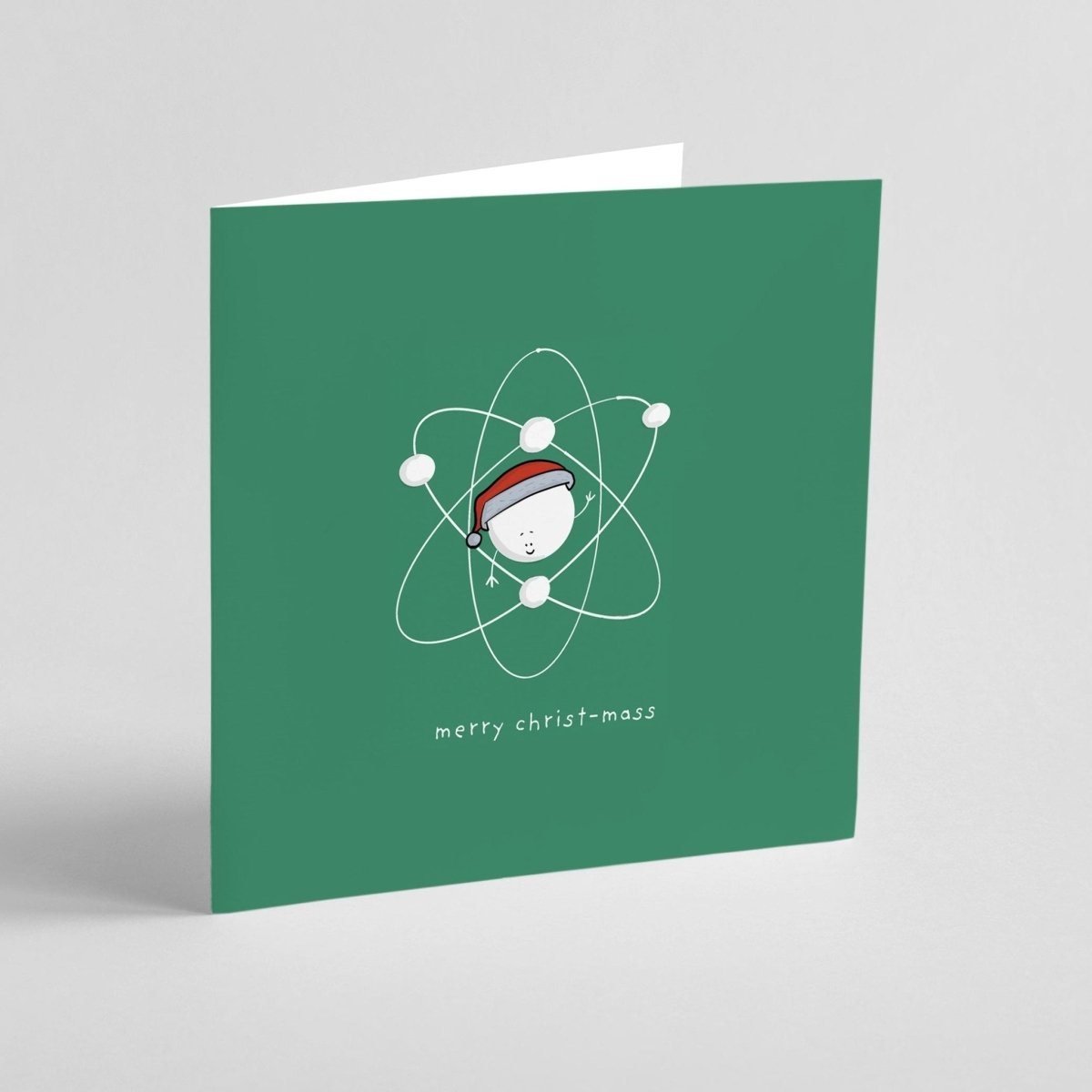 Green greeting card with a Christmas-themed atom design and 'merry christ-mass' text on a gray background.