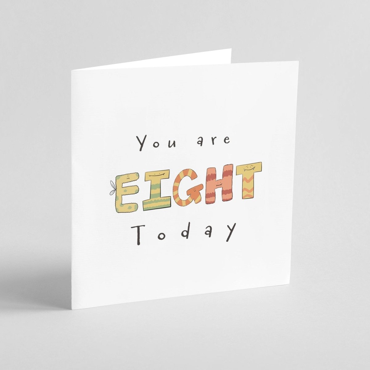 Monster-themed milestone birthday card showing EIGHT spelled with cute stripey monsters