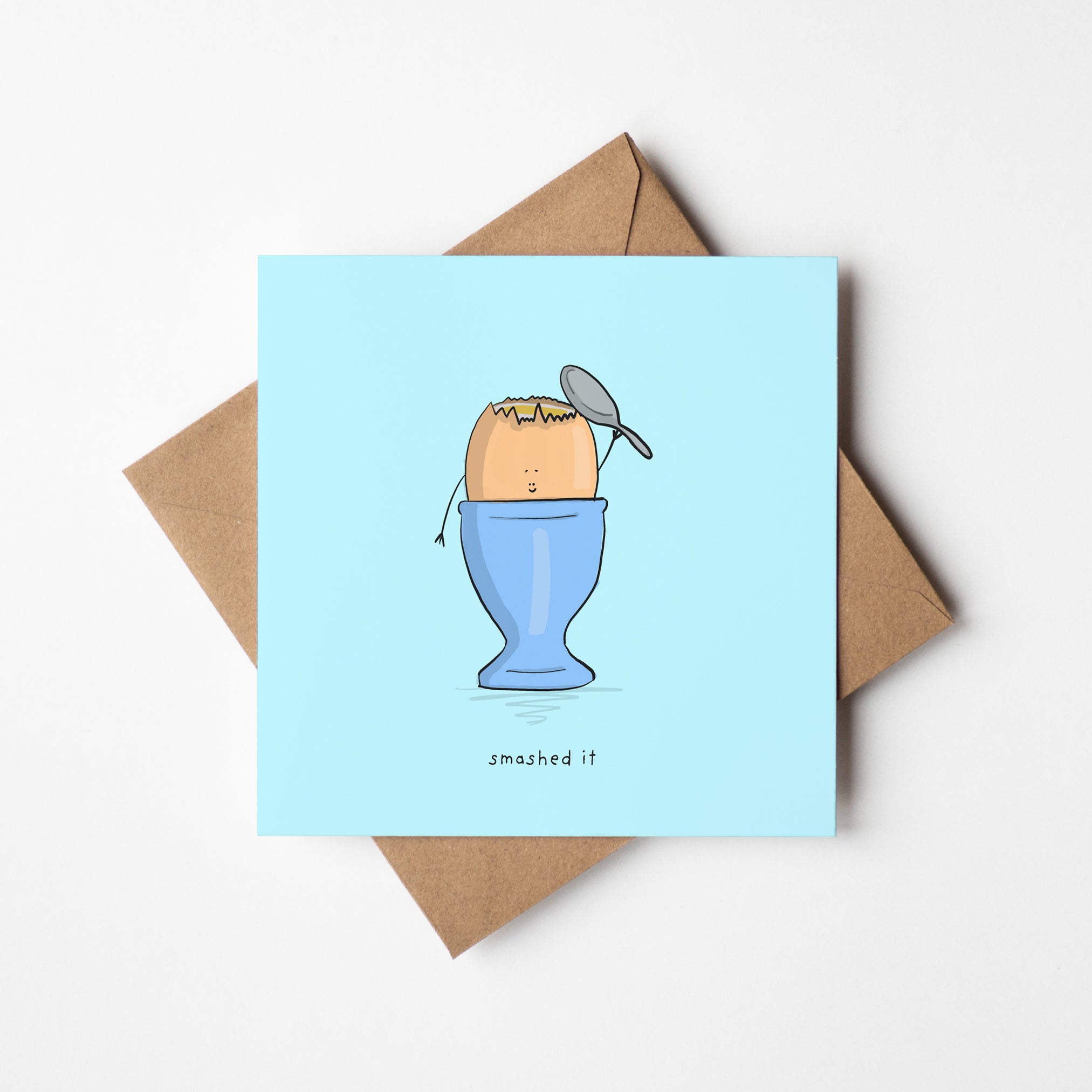 You Smashed It congratulations card featuring adorable egg character holding spoon in blue egg cup