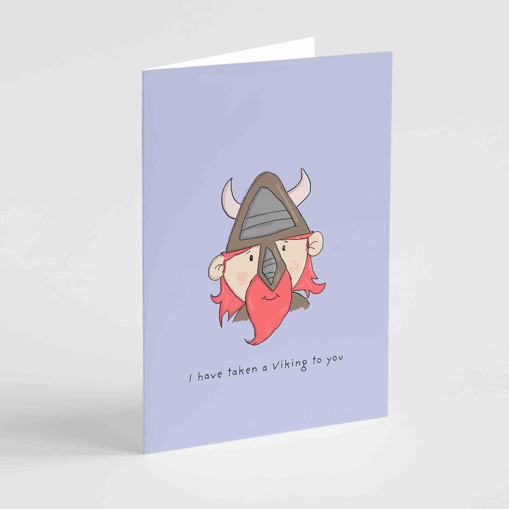 "Quirky 'I Have Taken a Viking to You' greeting card by Richard Darani, showcasing a cheerful Viking with a red beard against a purple background, ideal for expressing affection with hu