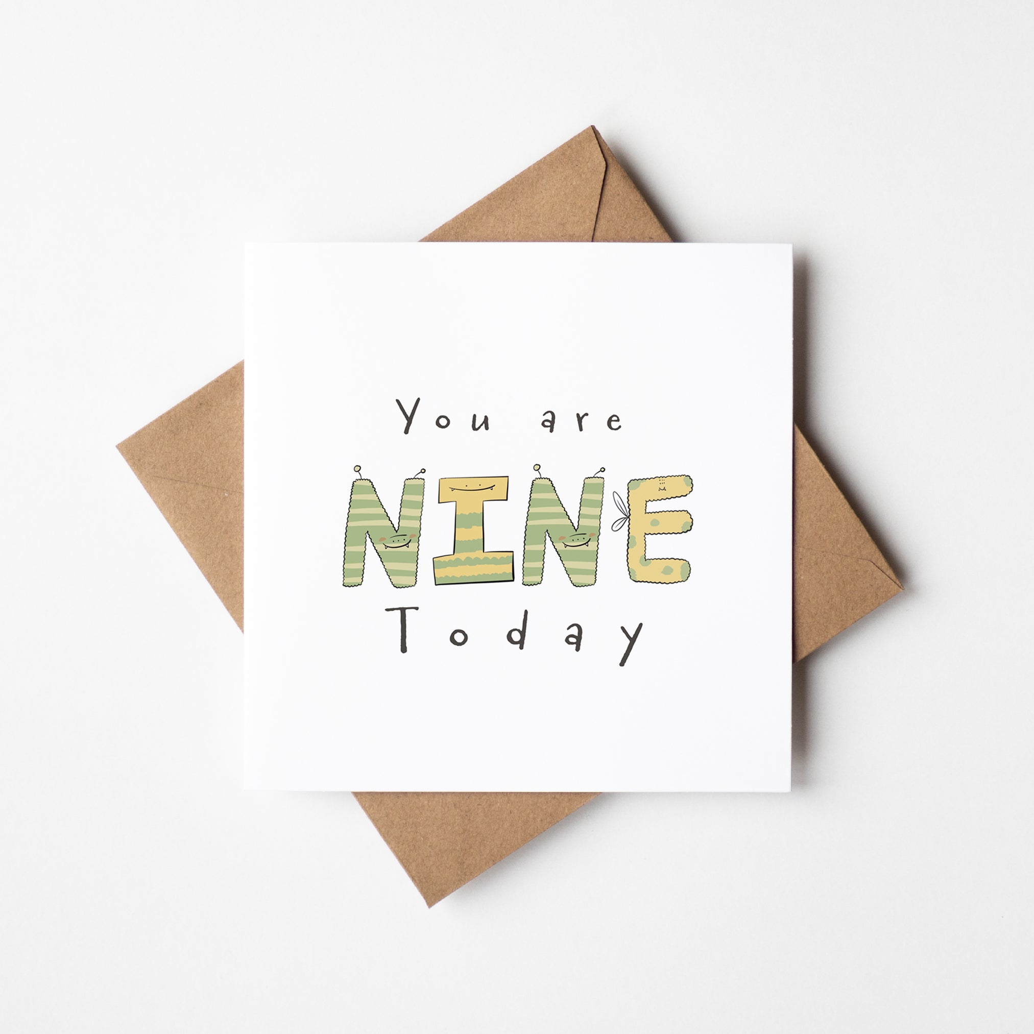un monster milestone birthday card mockup showing NINE spelled with cute monster characters