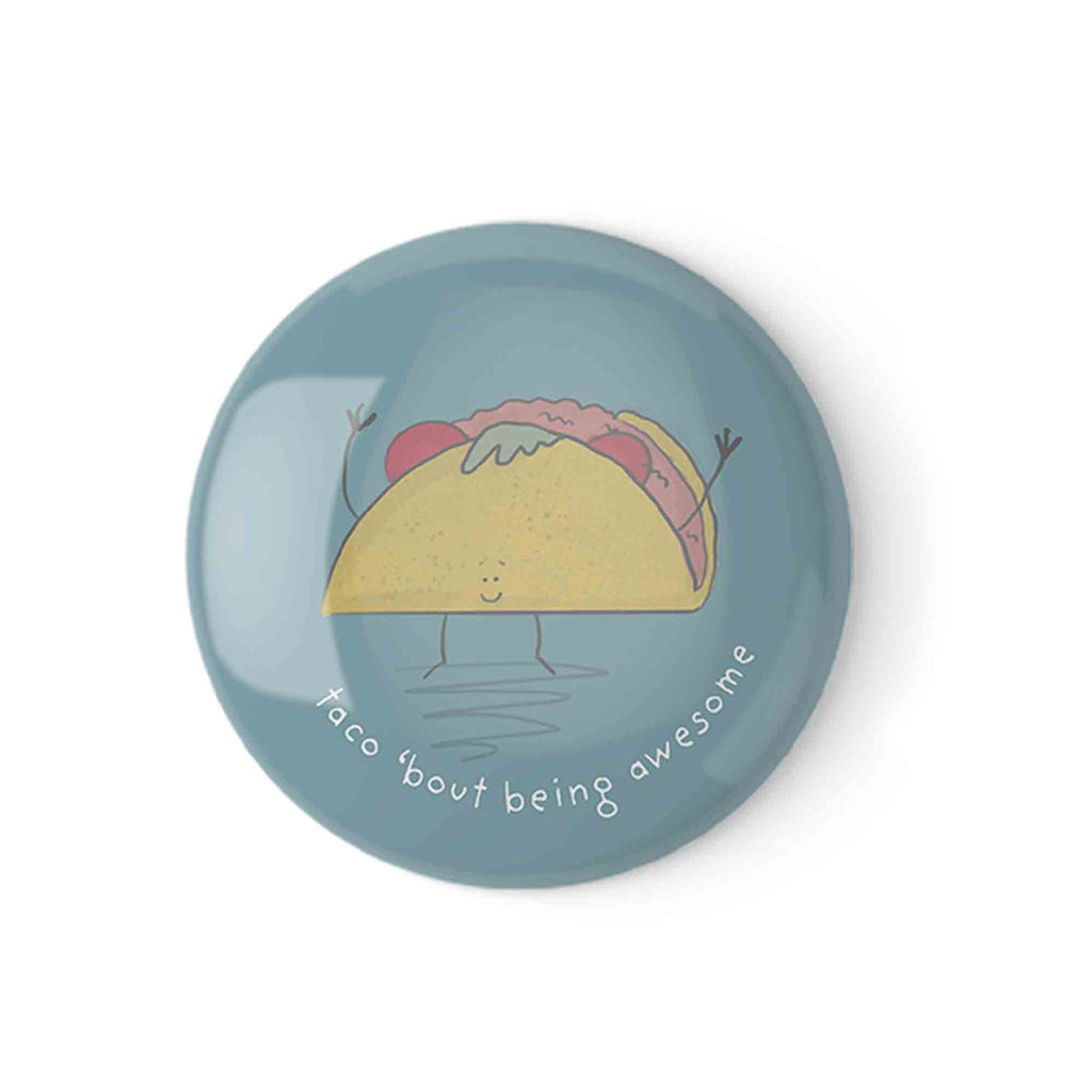 Button badge with an illustrated happy taco character saying 'Taco bout being awesome' on a blue background."