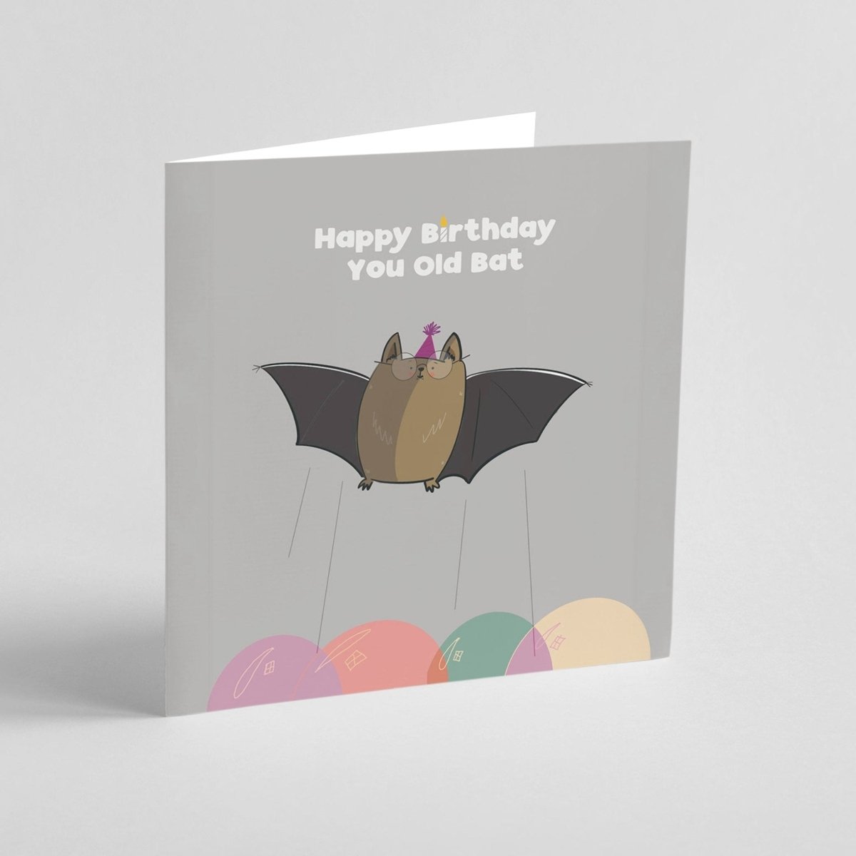Greeting card with a bat illustration and 'Happy Birthday You Old Bat' text on a gray background