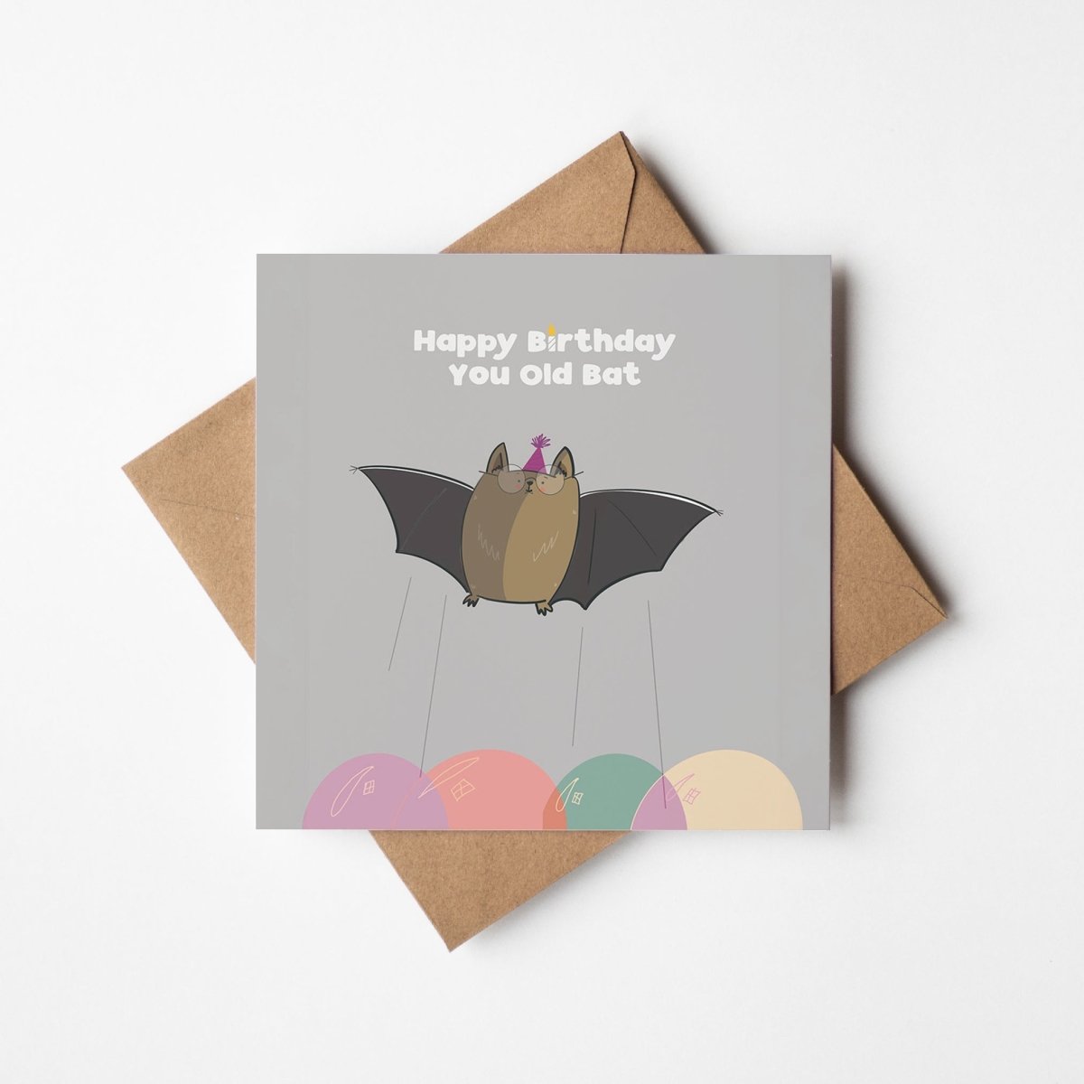 Birthday card with bat illustration and 'Happy Birthday You Old Bat' text, placed on a brown envelope.