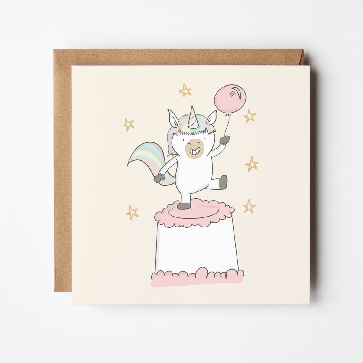 Magical Unicorn Birthday Card featuring whimsical unicorn on birthday cake with balloon and golden stars