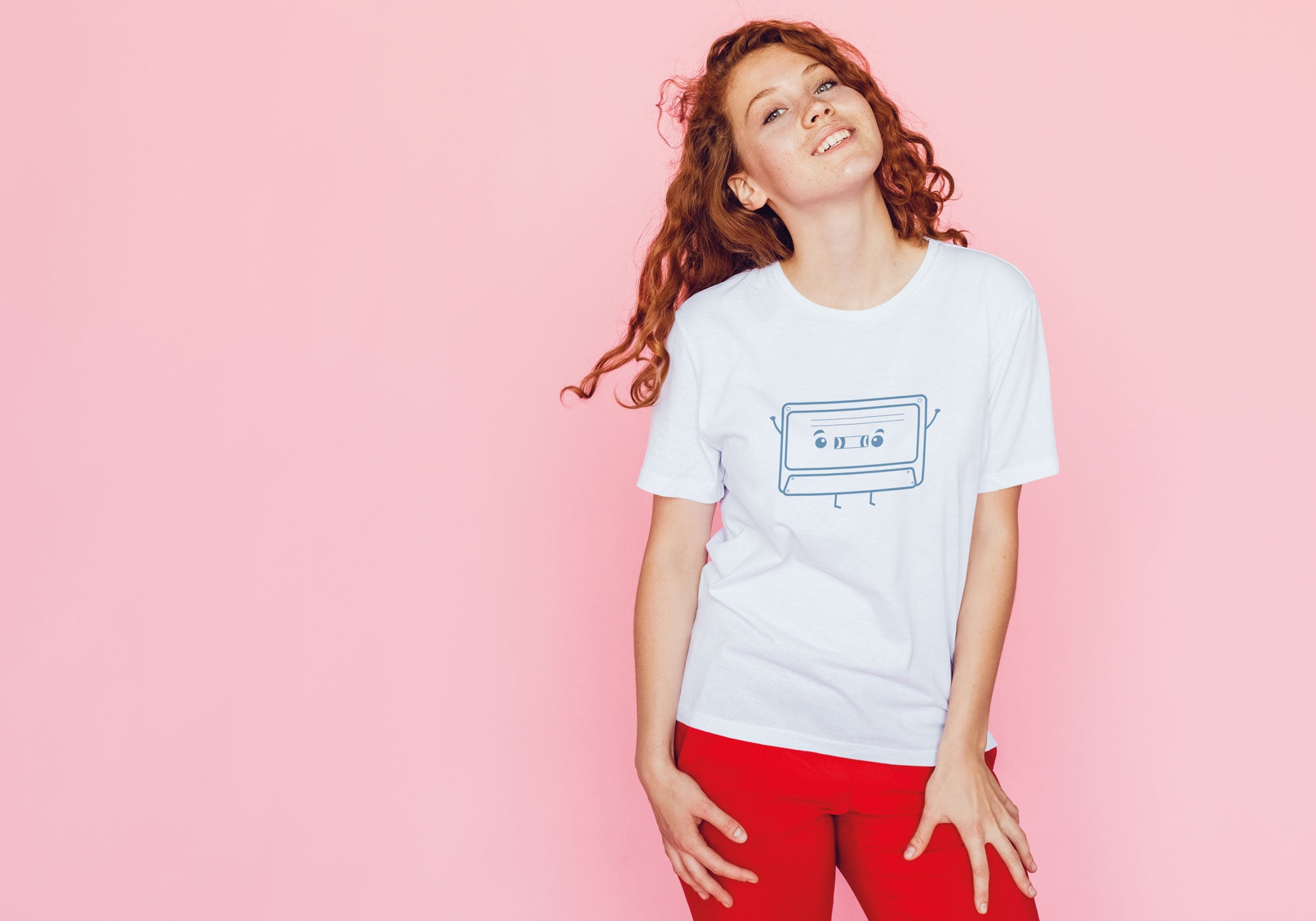 Model wearing a white T-shirt with a cassette character