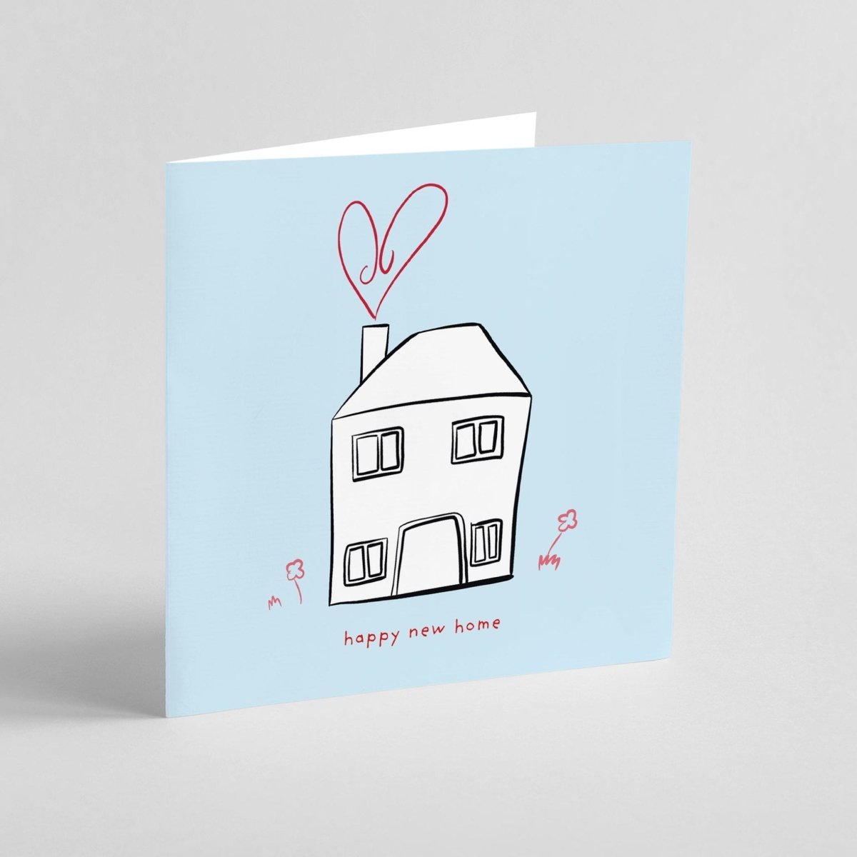 Greeting card with a house illustration and 'happy new home' text on a light blue background