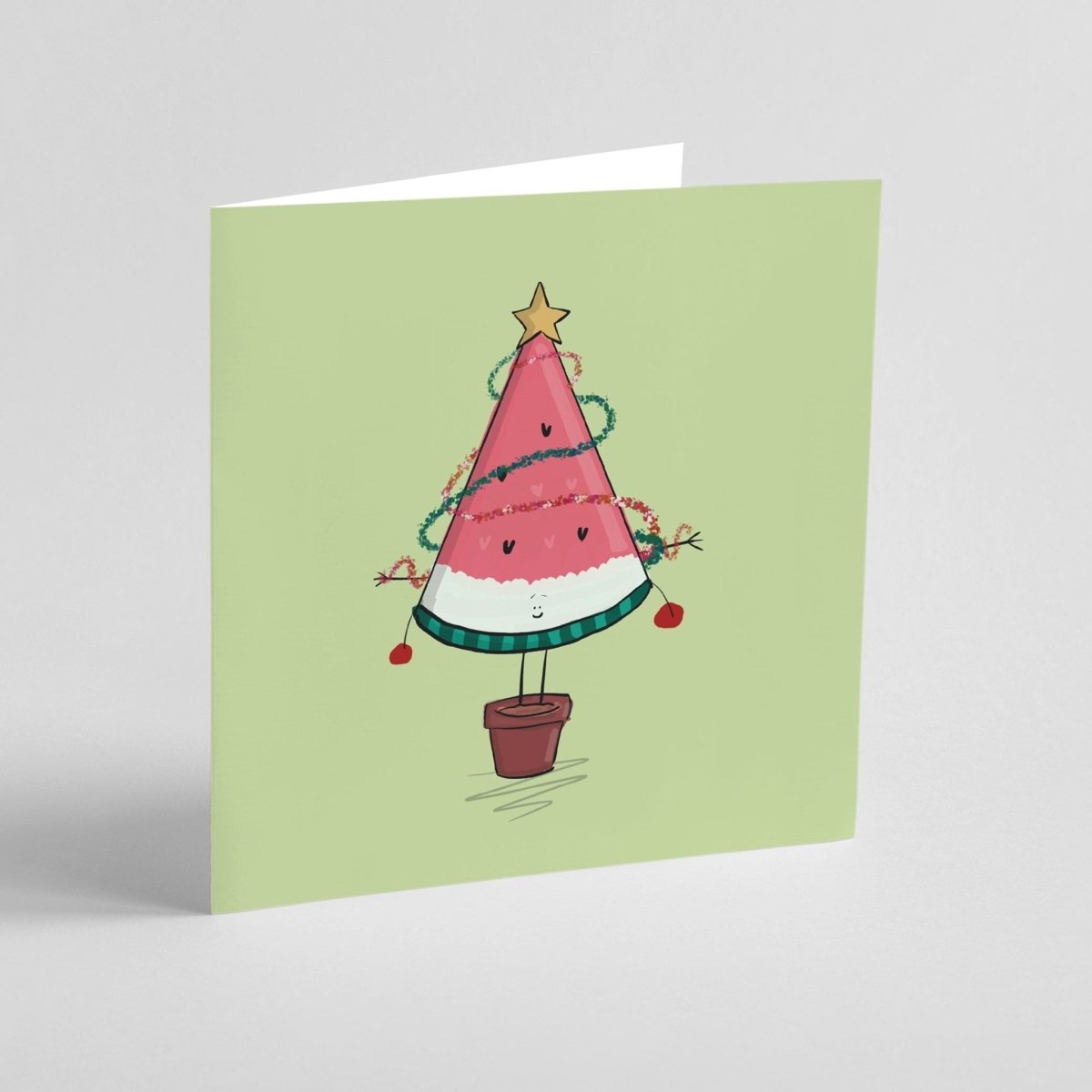 Funny fruit Christmas card with watermelon tree, tinsel, and star on top
