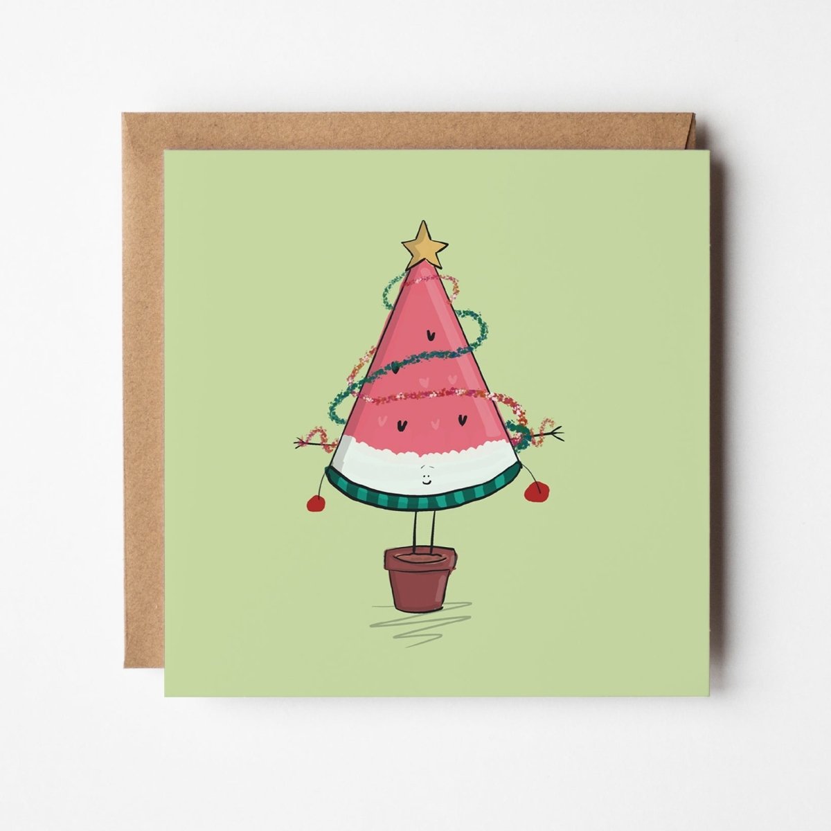 Quirky holiday greeting card featuring watermelon slice as Christmas tree with baubles