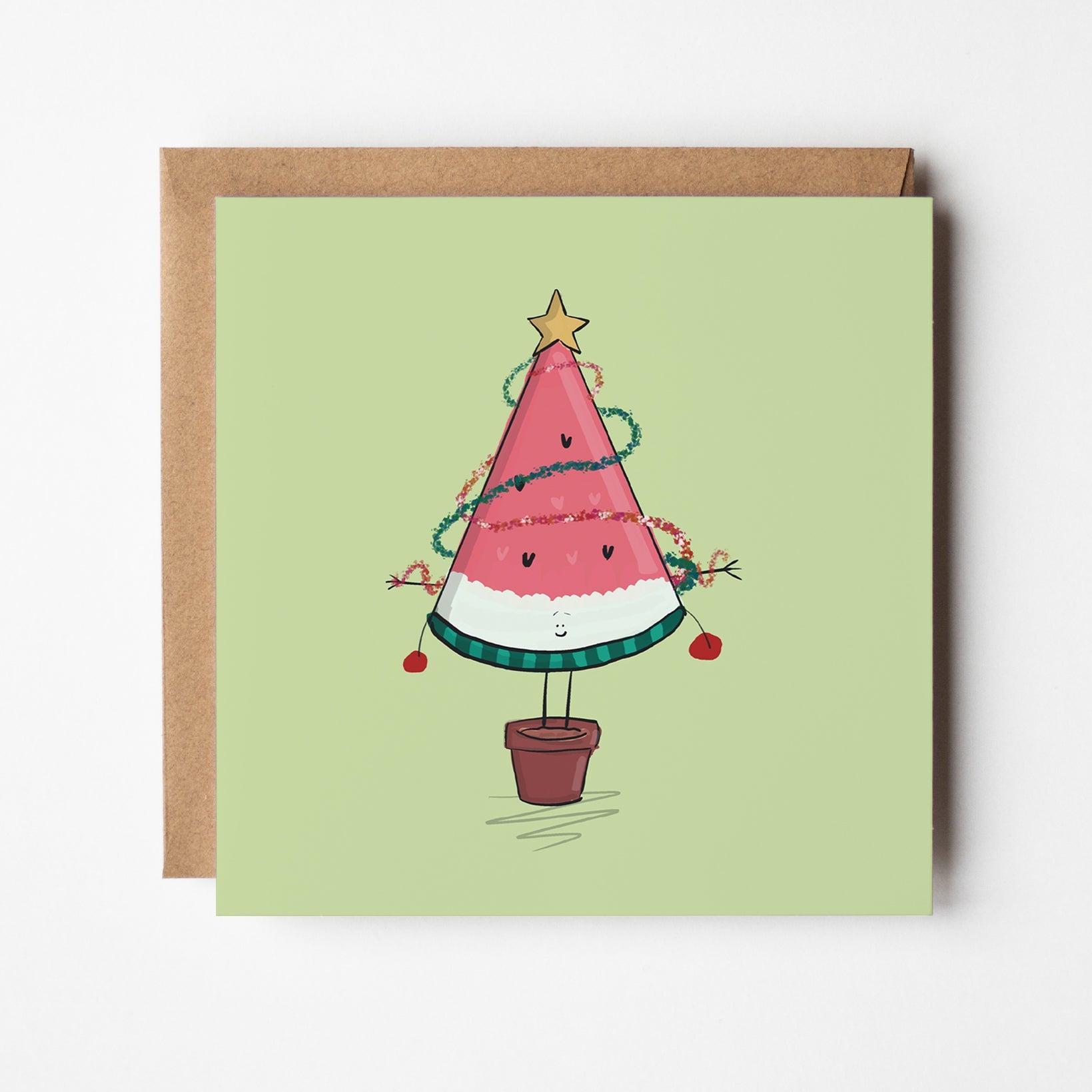 Quirky holiday greeting card featuring watermelon slice as Christmas tree with baubles