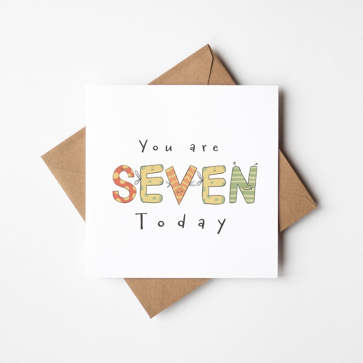 You're 7 Today monster birthday card with cute illustrated characters spelling out SEVEN