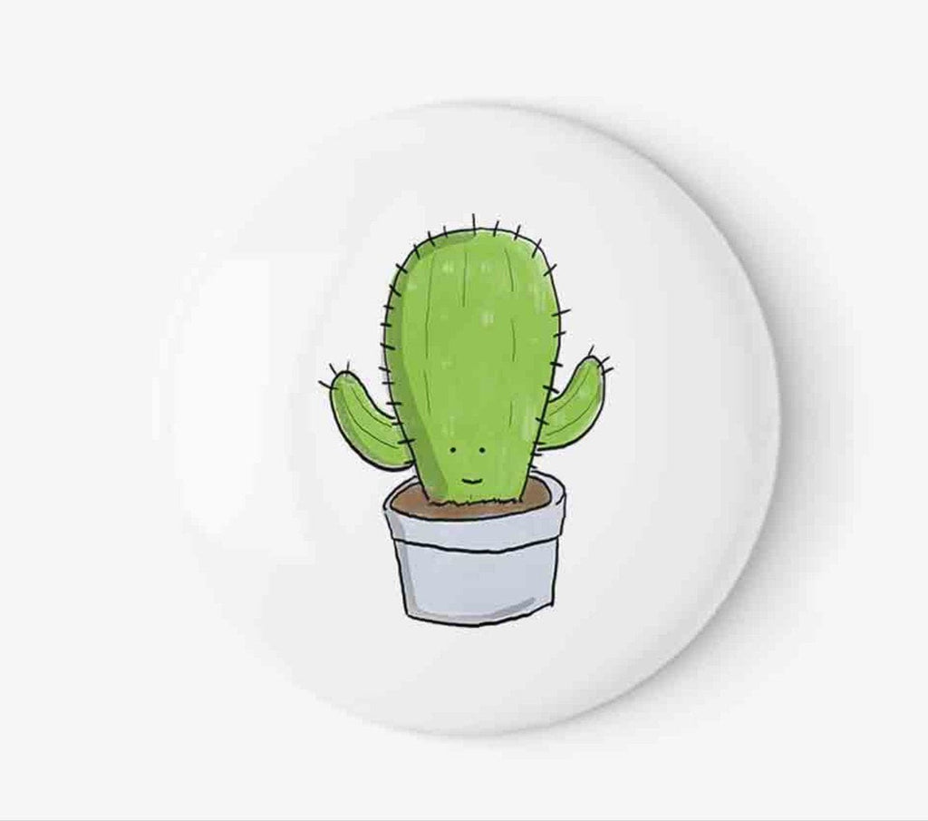 Quirky 'Cheery Cactus Badge' with a green cactus illustration in a terracotta pot, ideal for sprucing up lapels, bags, and hats with desert whimsy.