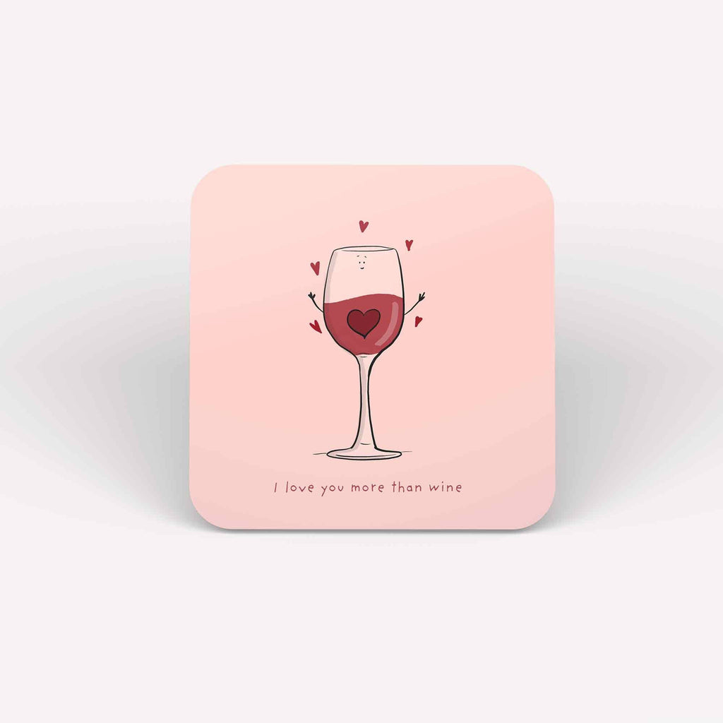 Set of 'I Love You More Than Wine' coasters with a wine glass and heart design on a pink background, symbolizing affection with a playful twist."