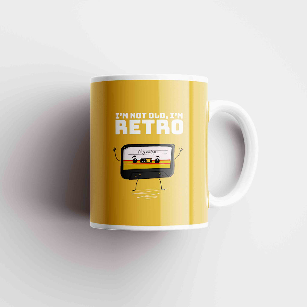 Retro-themed ceramic coffee mug with the phrase 'I'm Not Old, I'm Retro' in a playful, vintage font, accompanied by colorful, classic graphics."