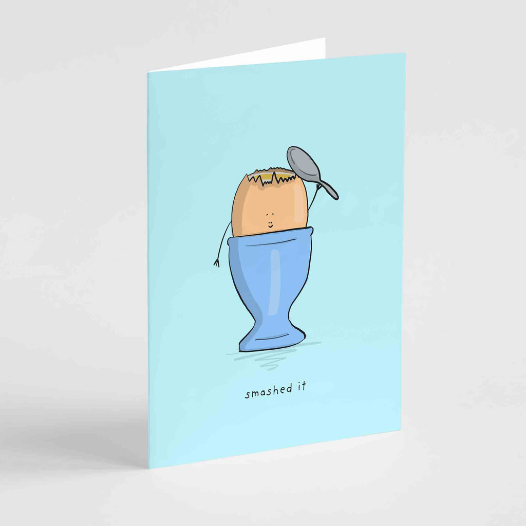 Illustration of a cheerful egg in an eggcup with a spoon, on Richard Darani's "Smashed it" congratulations greeting card.
