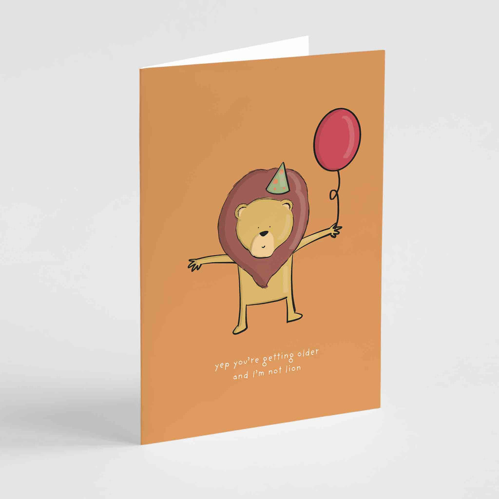 Humorous birthday card featuring a stylish lion in a party hat with the pun "Not Lion About Your Age"